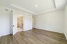 tray ceilings and hardwood vinyl plank with multiple windows. 