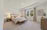 carpet throughout with tray ceilings and multiple windows