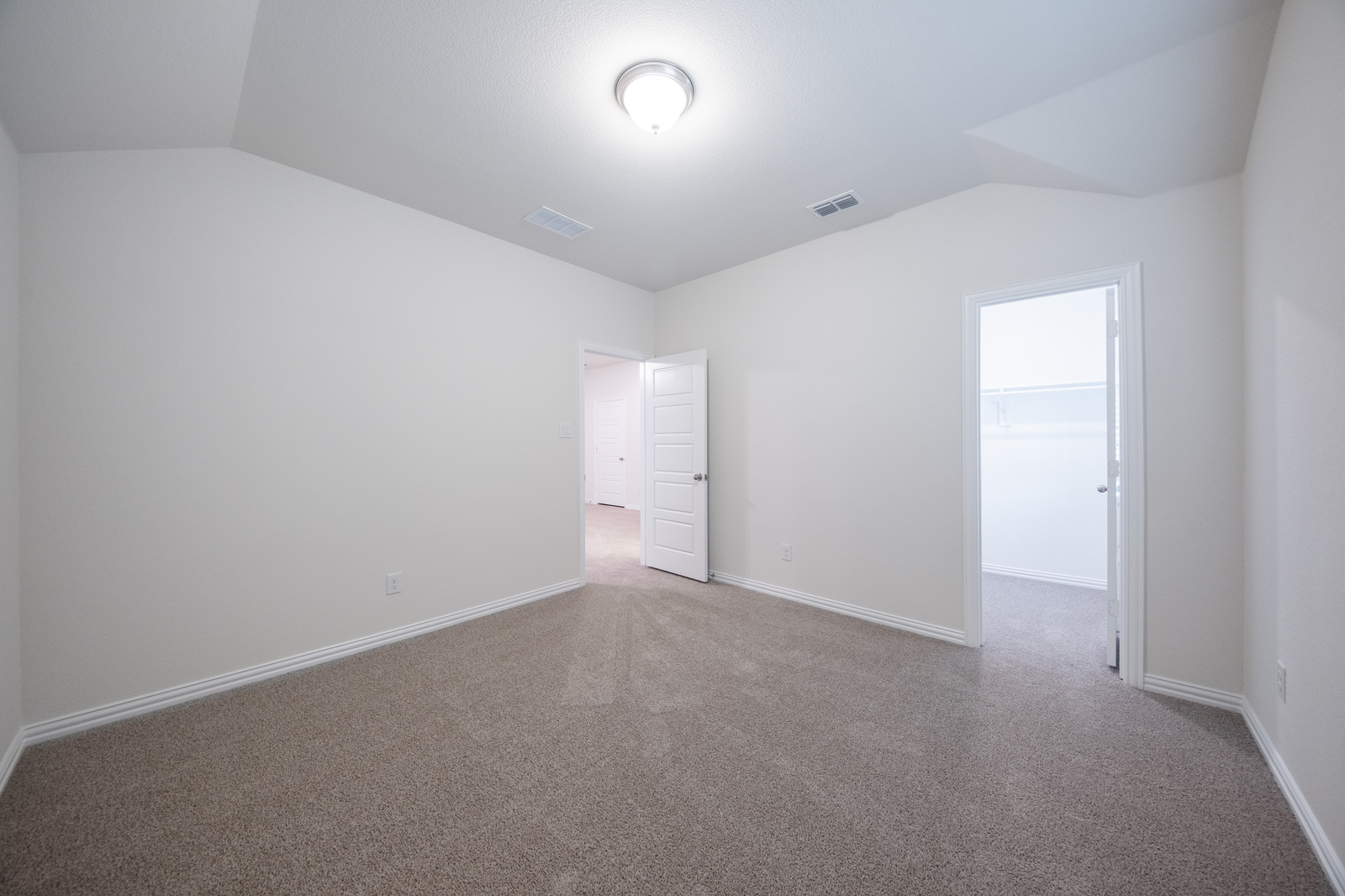 guest bedroom with carpet and walk-in closet