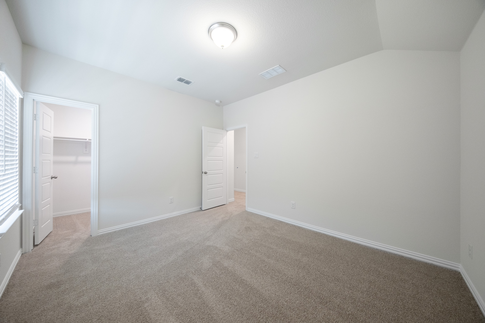 guest bedroom with carpet and walk-in closet