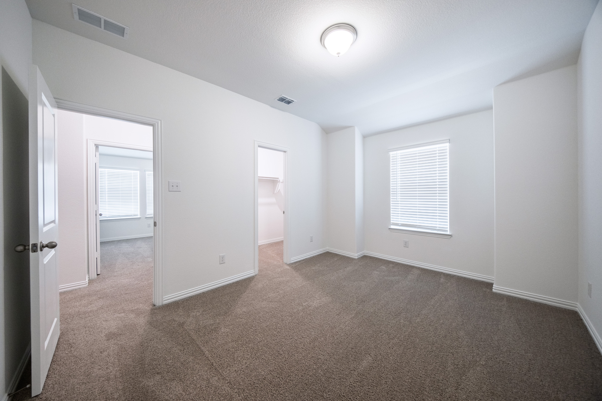 guest bedroom with carpet and window