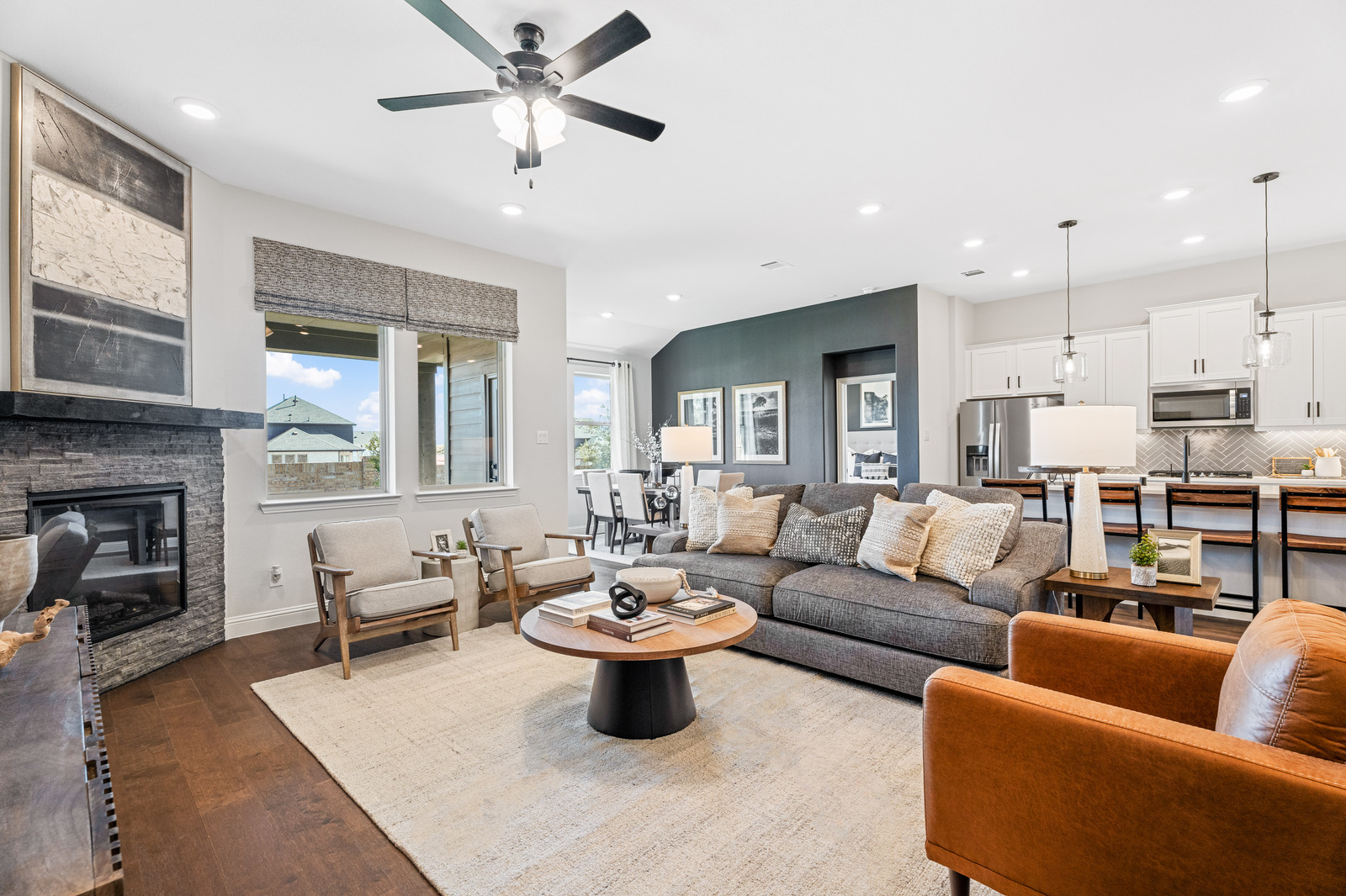 great room with large windows and a fireplace