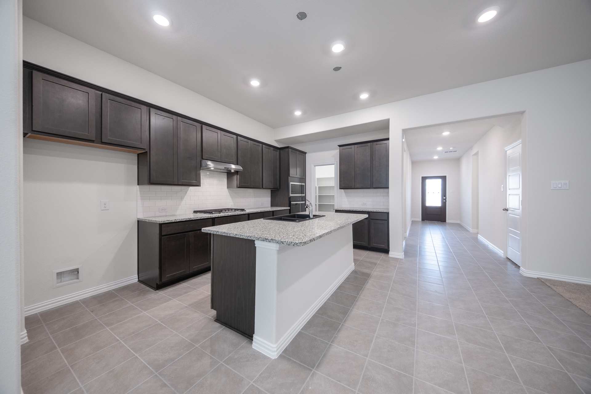 open kitchen with dark brown cabinets