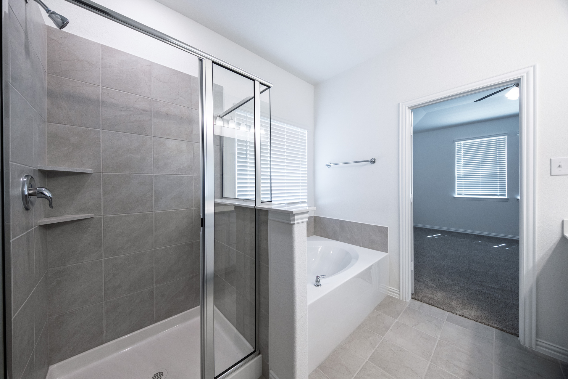 primary bathroom with separate walk-in shower and soaking tub