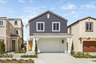 exterior of two-story home with orange door and desert landscaping