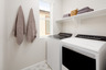 laundry room with window and tile floors