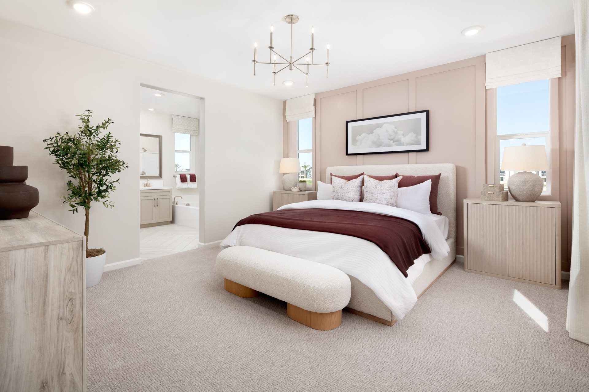 primary bedroom with neutral carpet and large windows