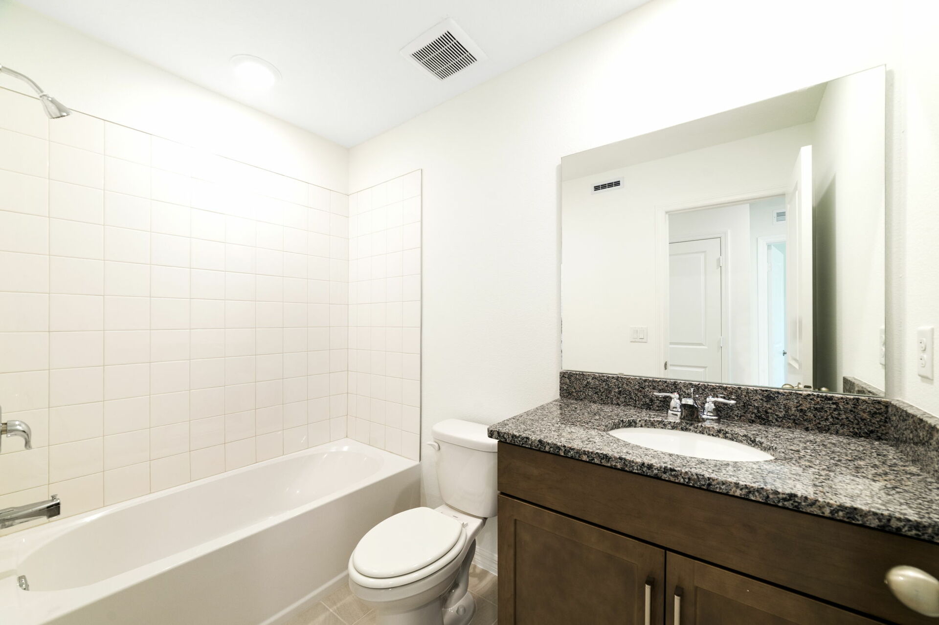 single sink vanity, water closet, and shower