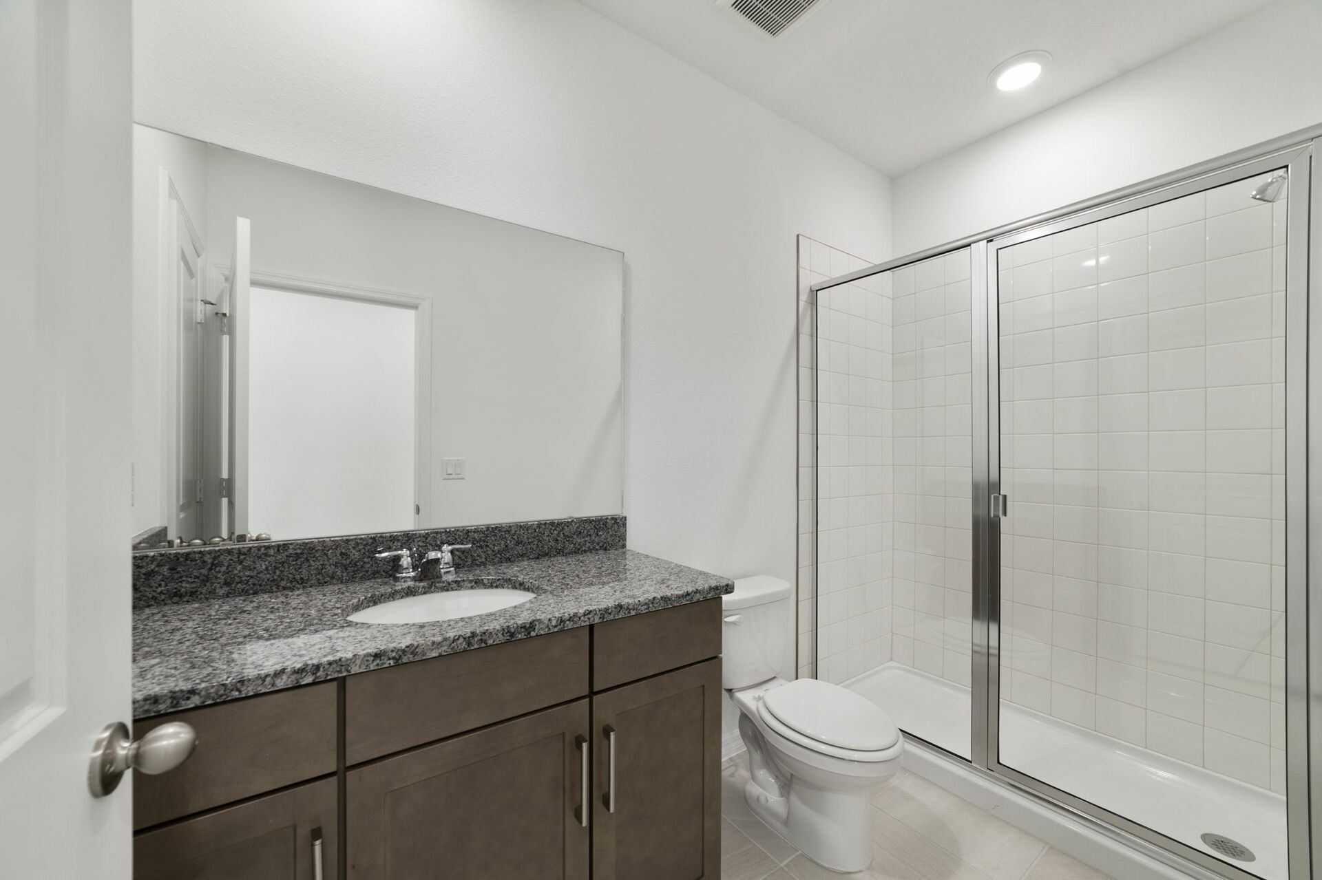 single sink vanity with water closet and shower