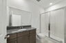 single sink vanity with water closet and shower