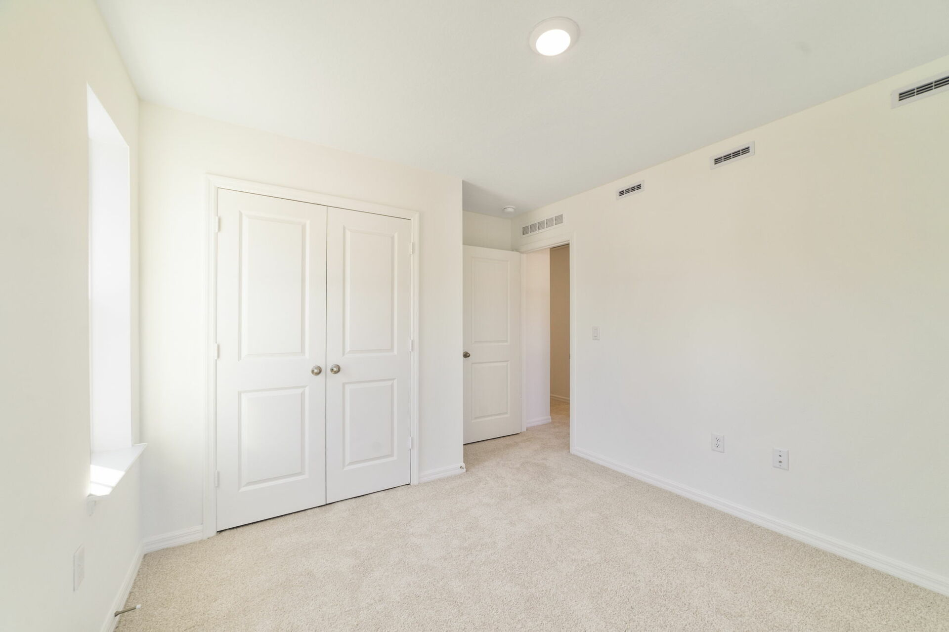 room with carpet throughout, single window and access to the closet