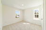 room with carpet throughout, single window and access to the closet