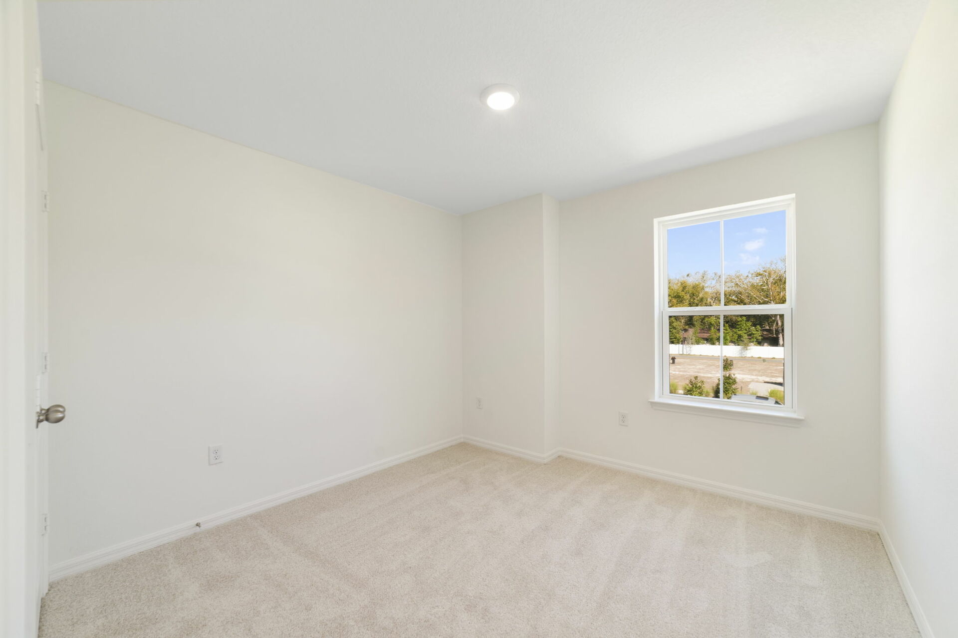 room with carpet throughout single window and closet.