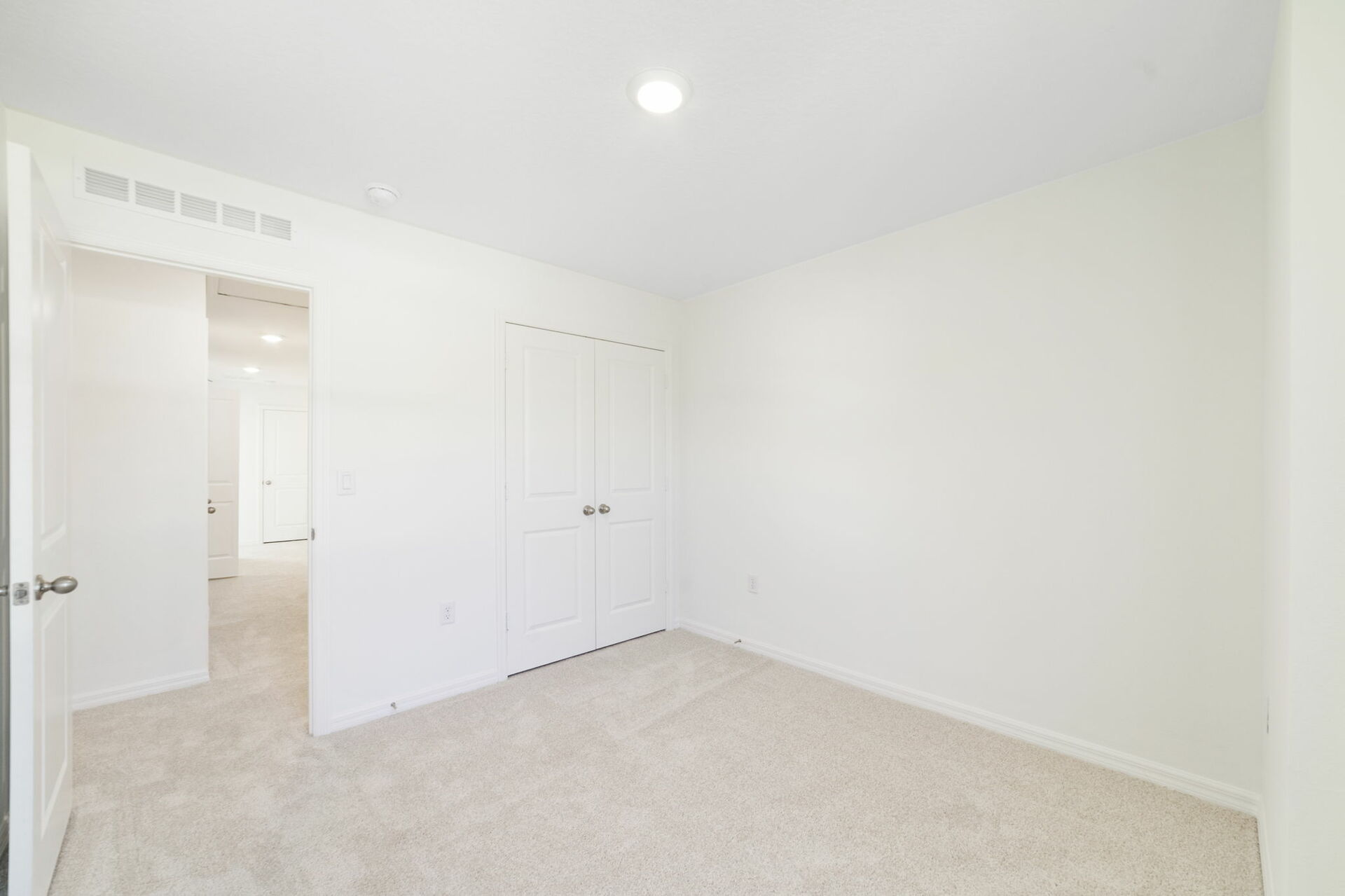 room with carpet throughout single window and closet.