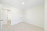 room with carpet throughout single window and closet.