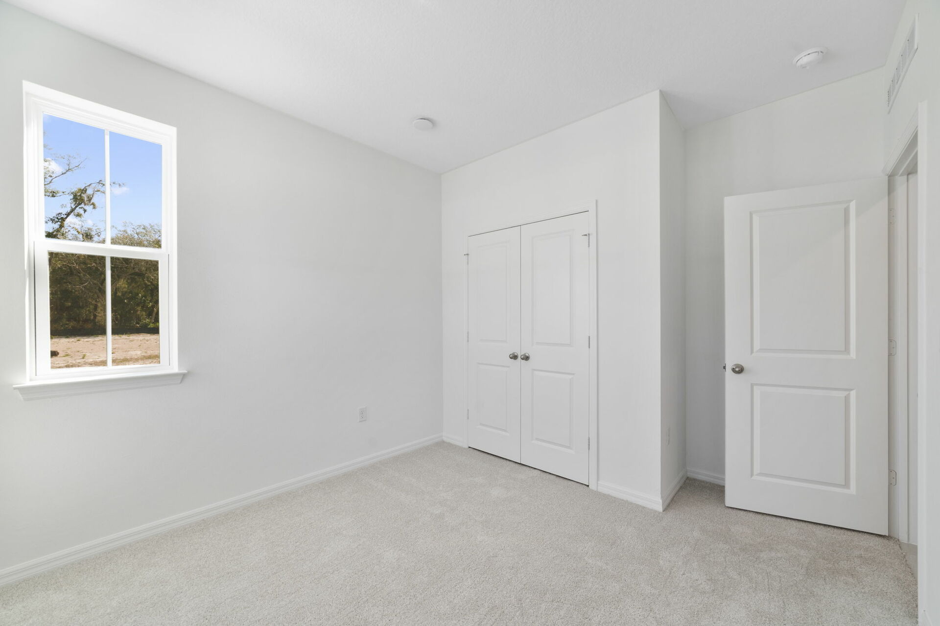 room with carpet throughout and multiple windows 