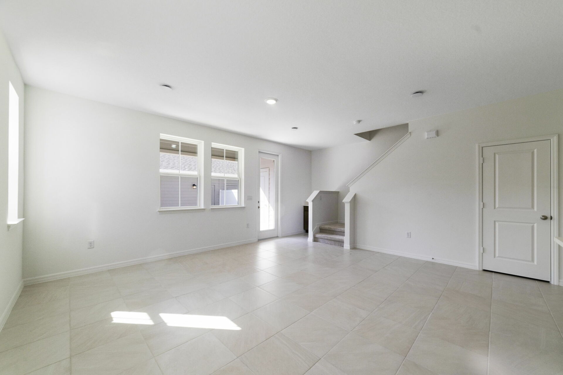 room with access to covered lanai and view of the kitchen
