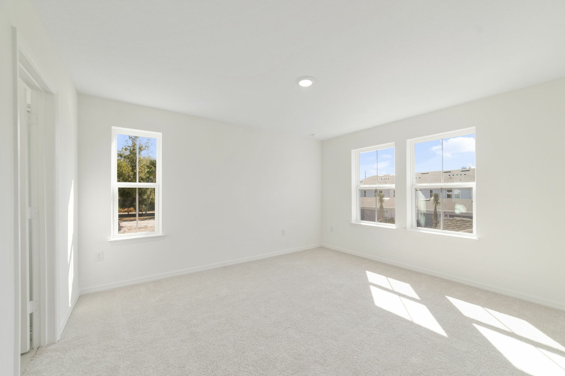 room with sitting area, carpet throughout and access to the primary bathroom