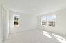 room with sitting area, carpet throughout and access to the primary bathroom