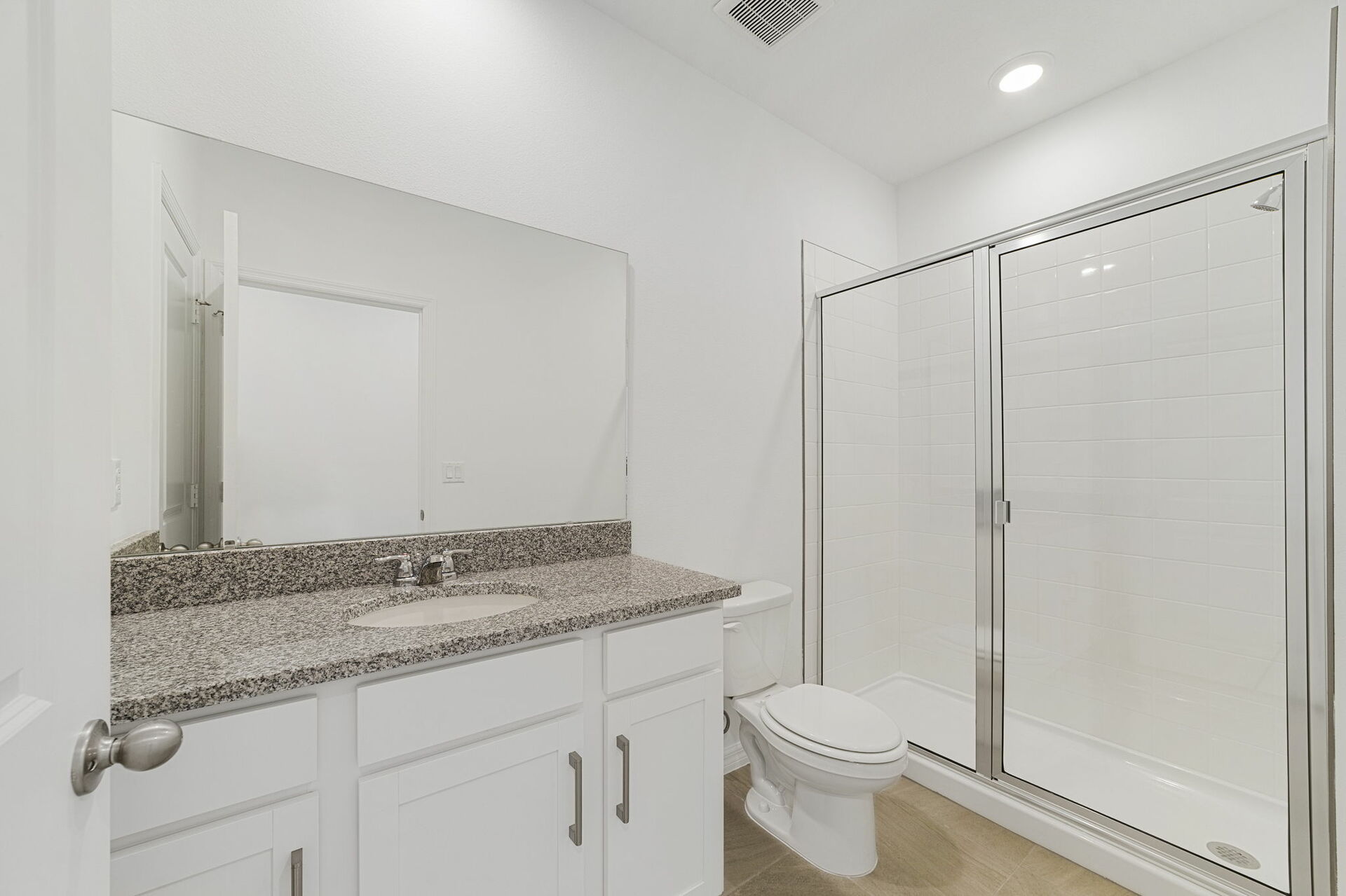 single sink vanity, water closet and shower