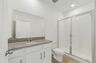 single sink vanity, water closet and shower