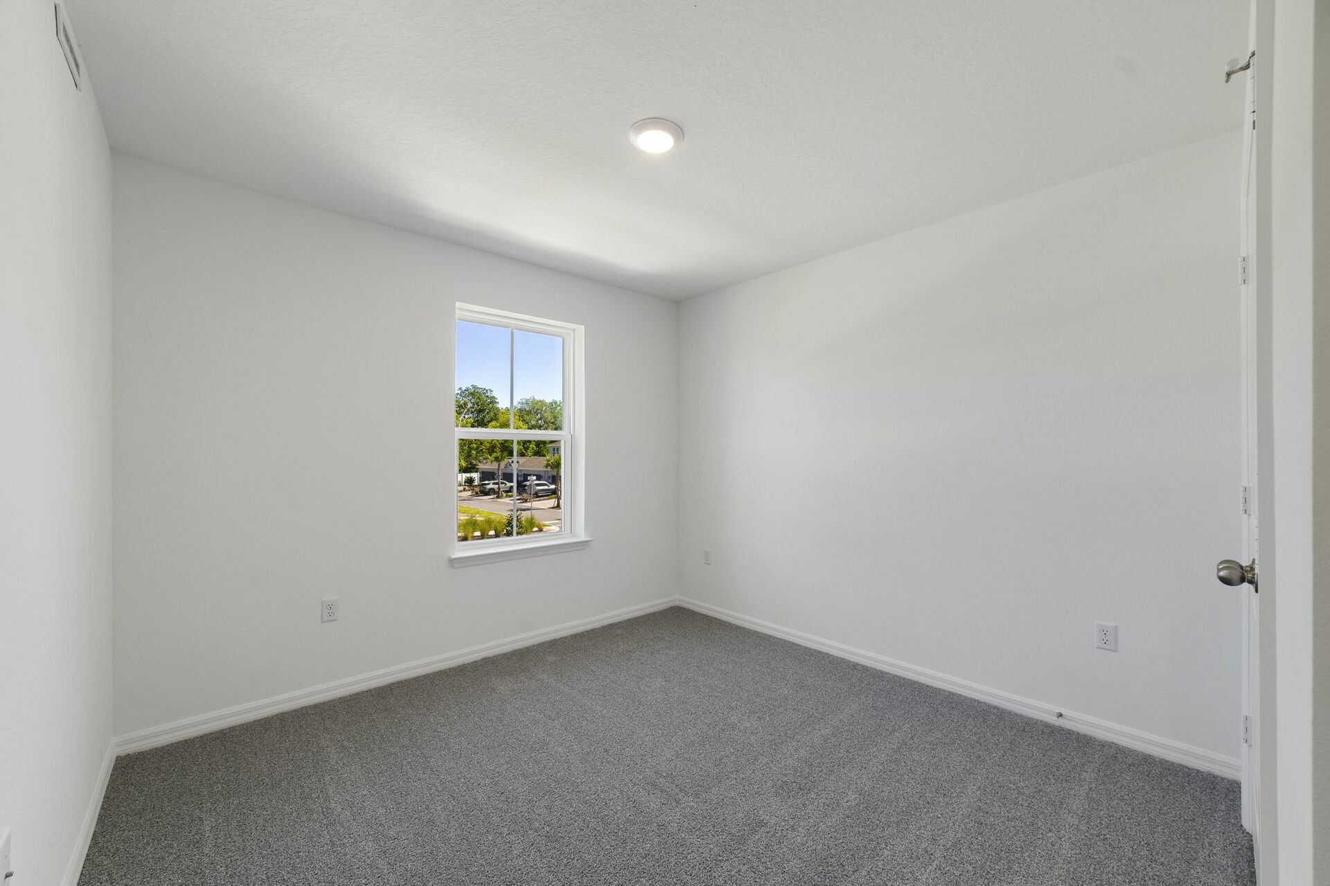 carpet throughout with a single window and closet