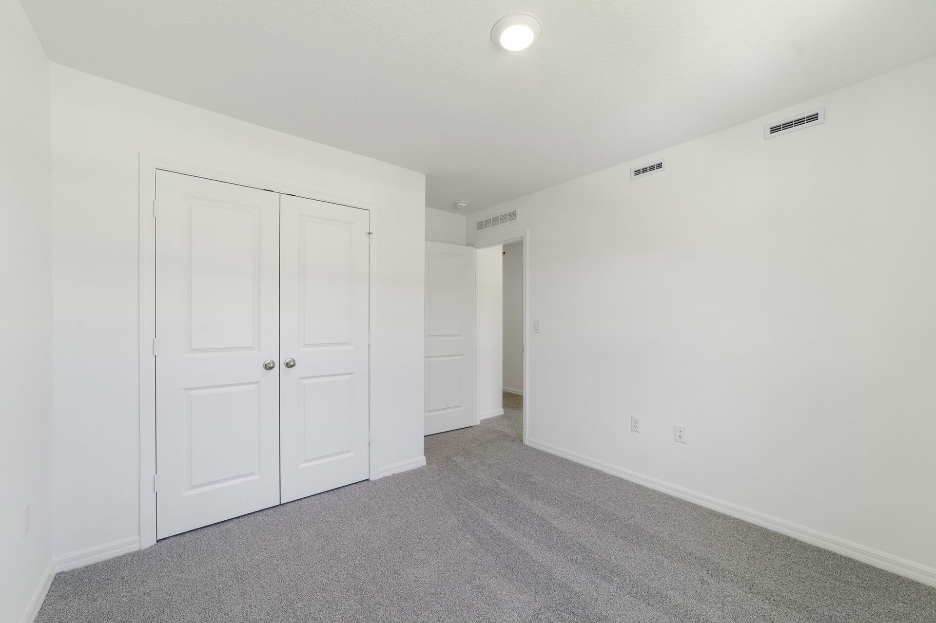 carpet throughout with a single window and closet