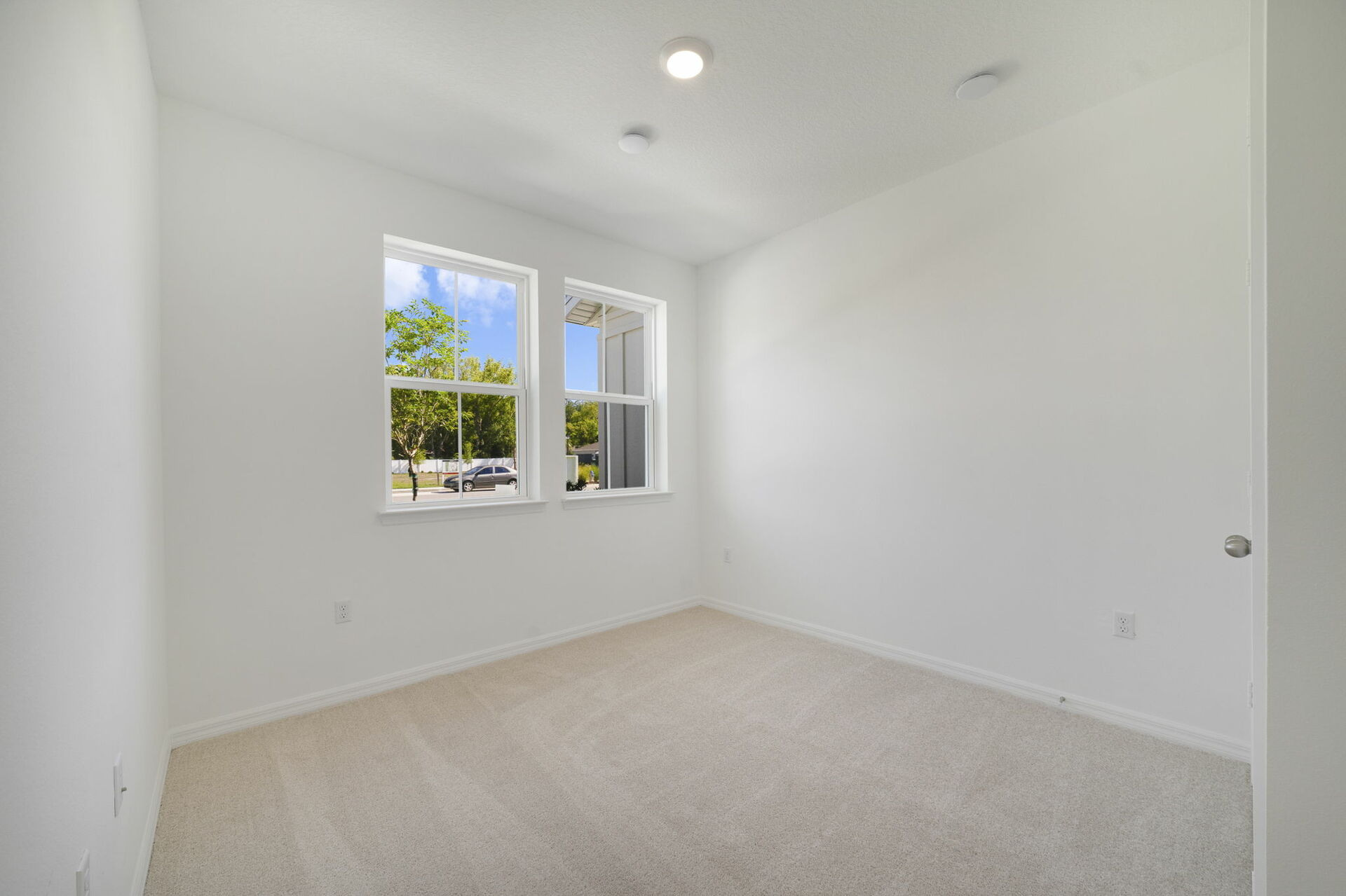 room with carpet throughout and dual window