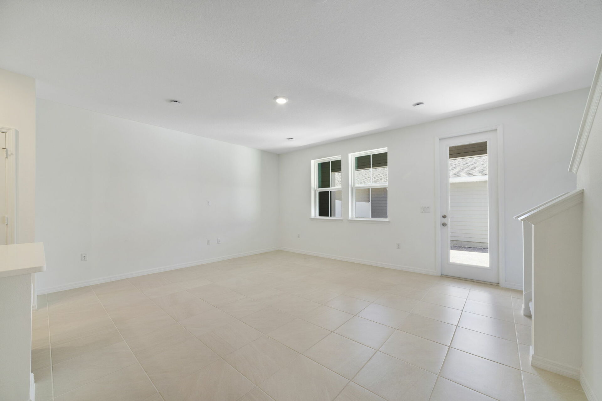 room with access to the covered lanai and the kitchen