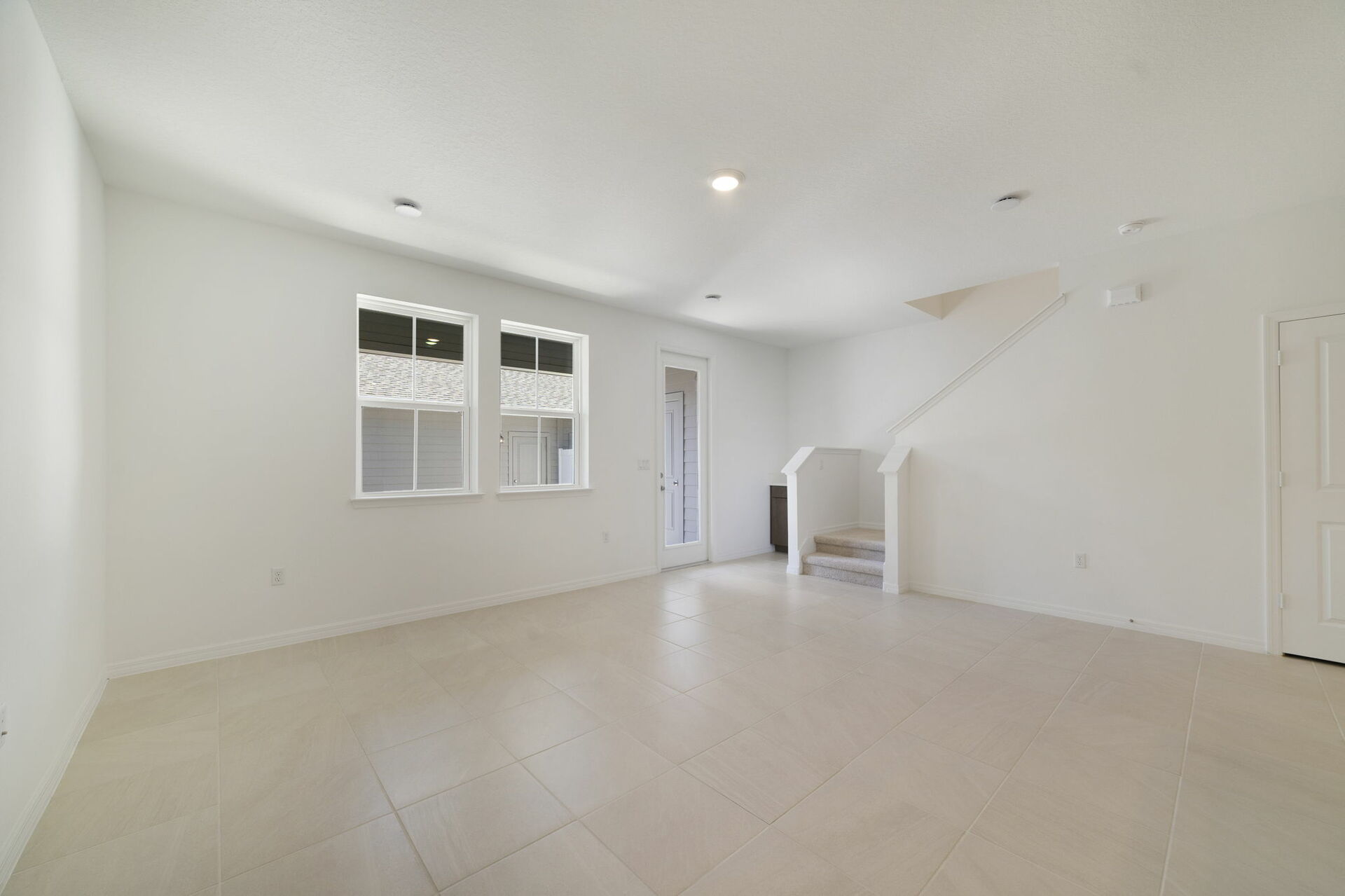room with access to the covered lanai and the kitchen