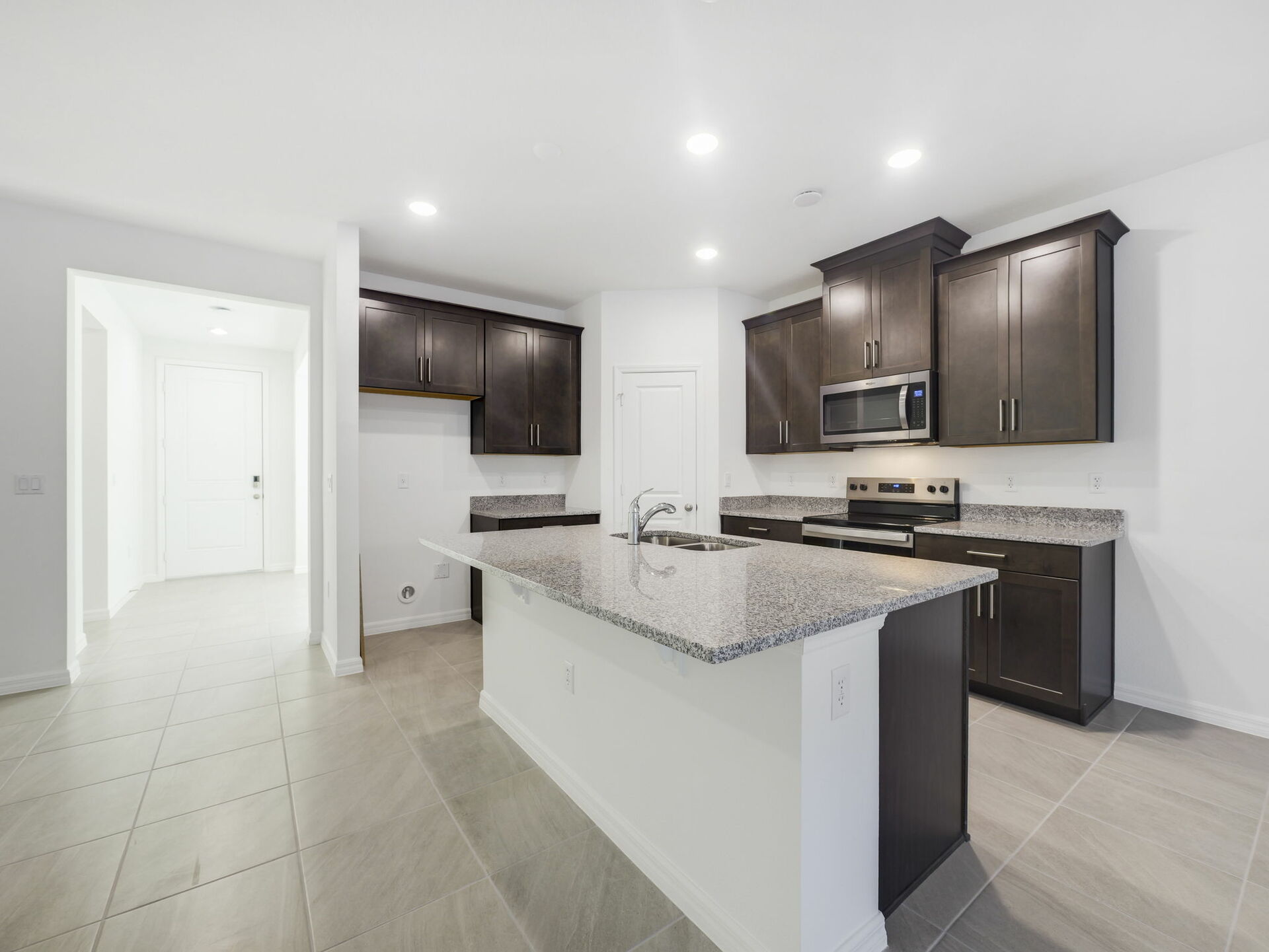 kitchen with dark brown cabinets and granite countertops