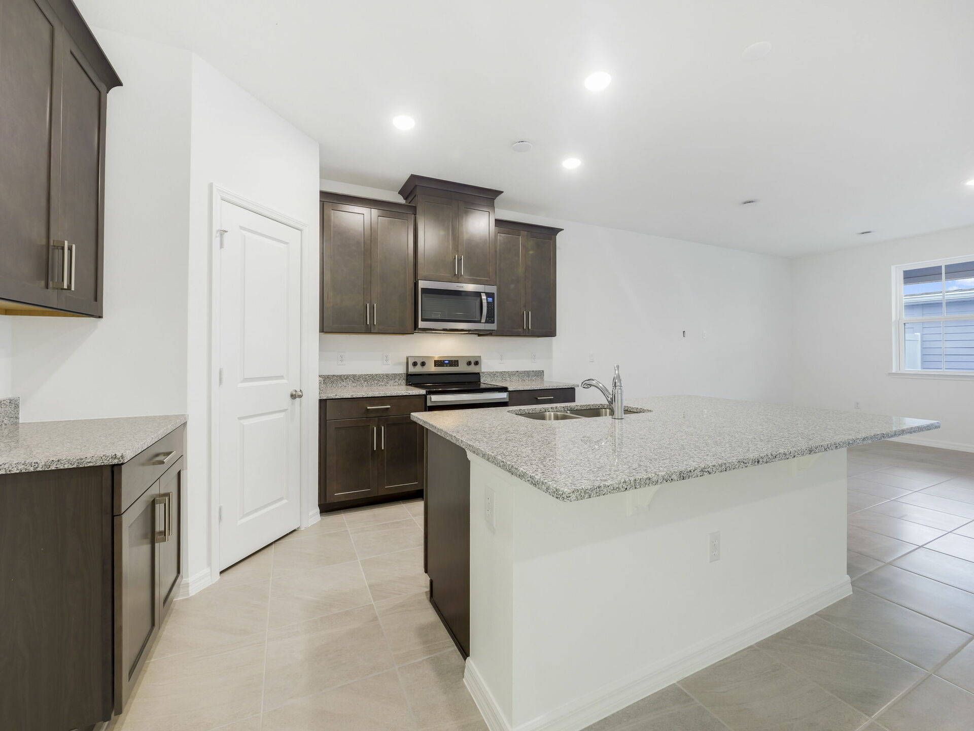 kitchen with dark brown cabinets and granite countertops