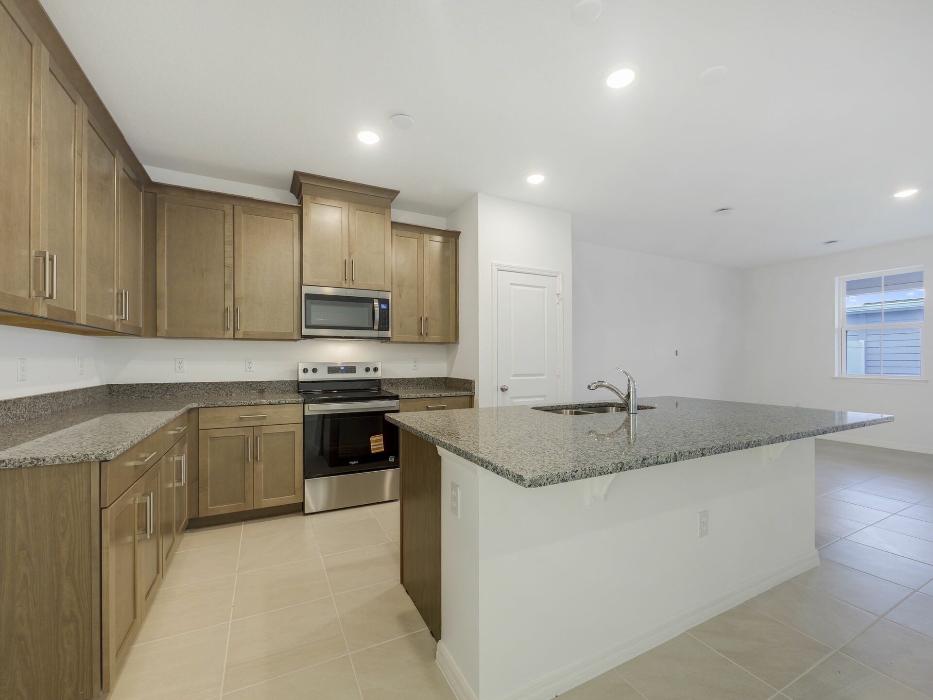 kitchen with brown cabinets and granite countertops
