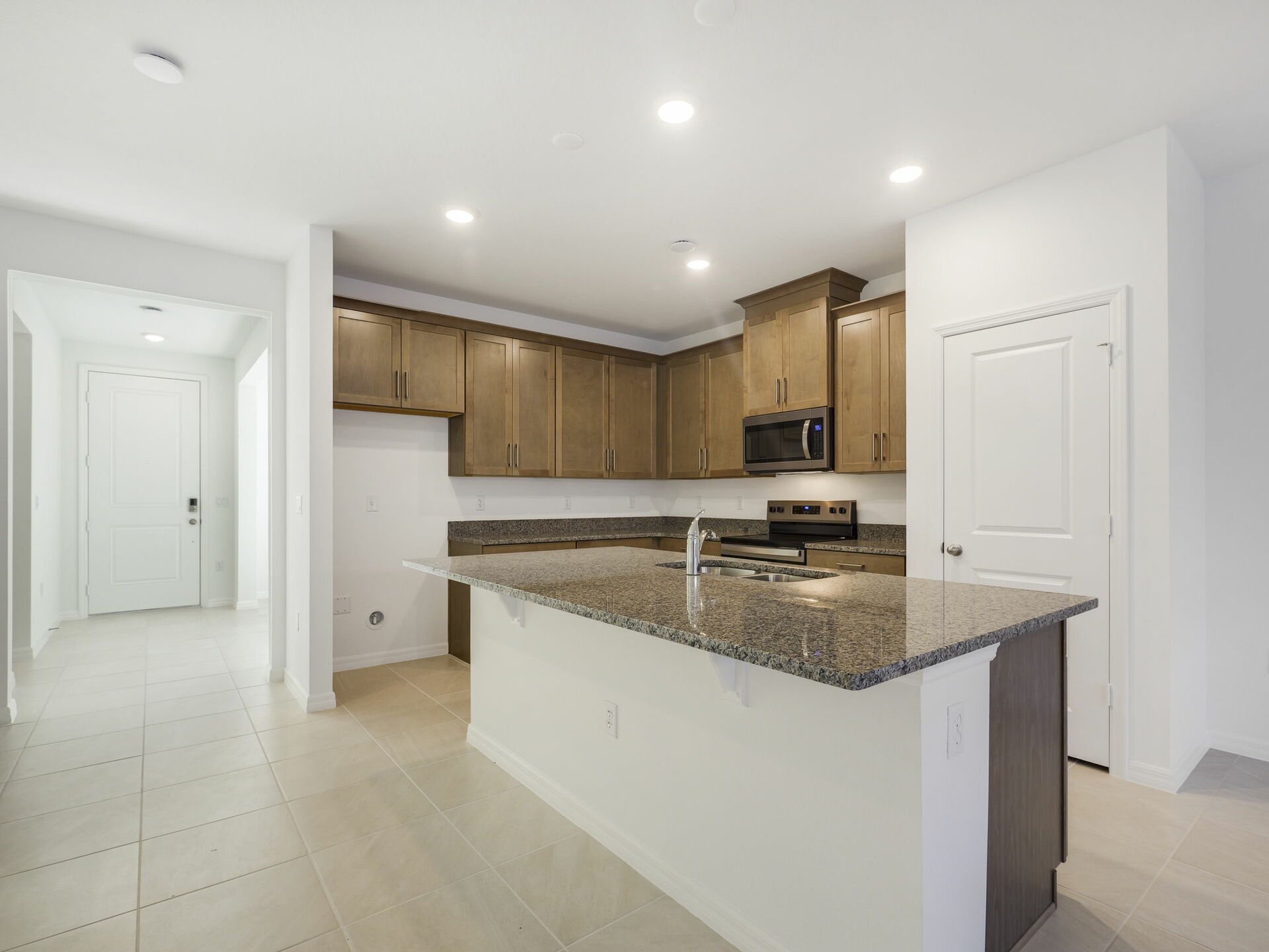 kitchen with brown cabinets and granite countertops