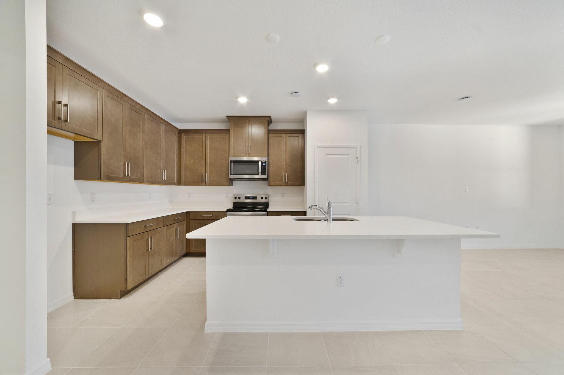 kitchen with island and view of great room and dining room