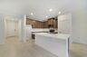 kitchen with island and view of great room and dining room