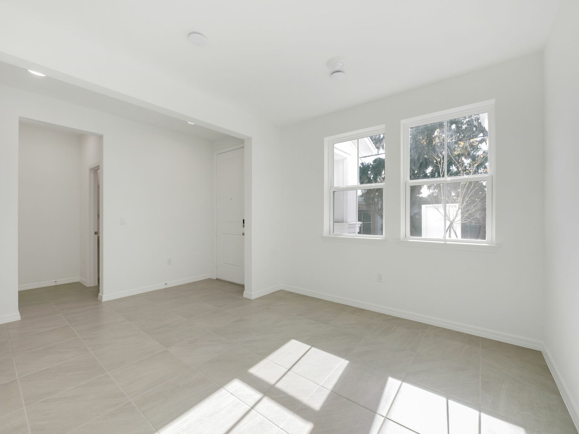 living room with tile flooring and two windows