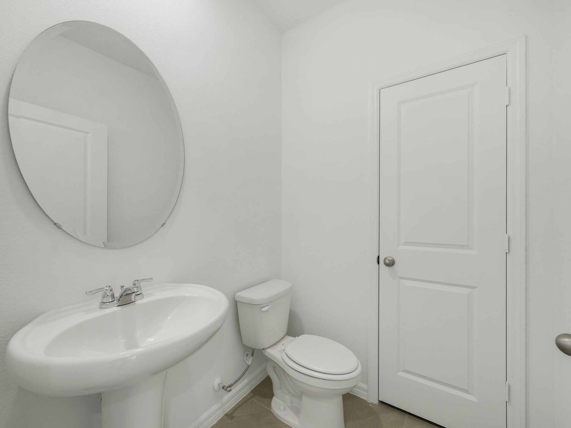 powder bathroom with mirror and pedestal sink
