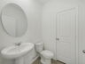 powder bathroom with mirror and pedestal sink