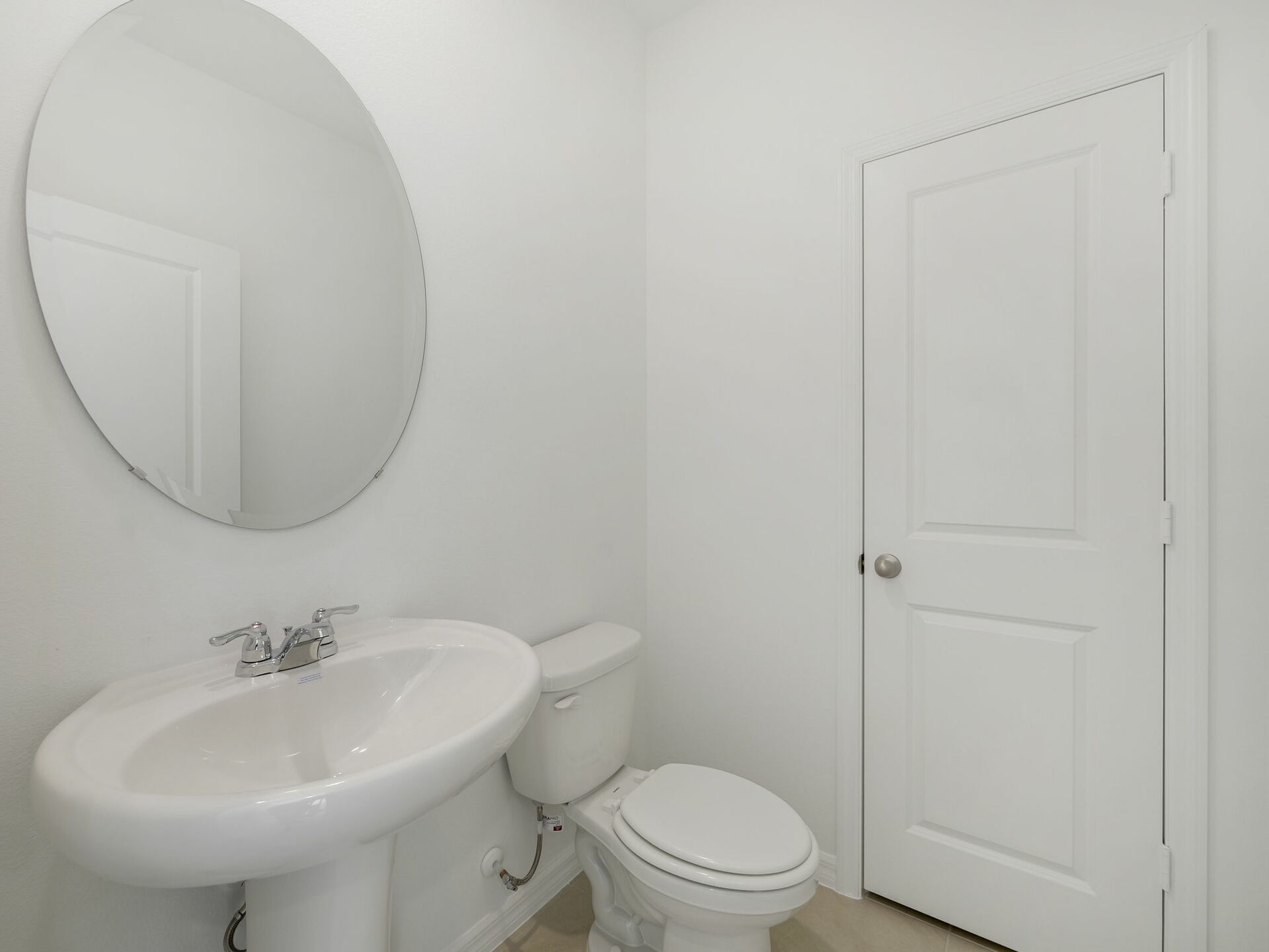 powder bathroom with mirror and white pedestal sink