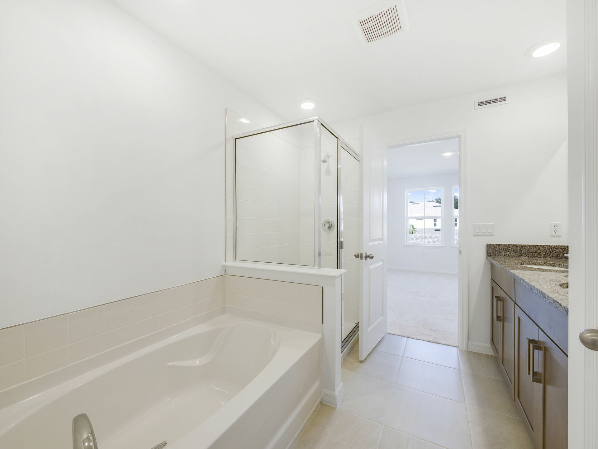 primary bathroom with separate shower and tub