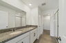 Dual sink vanity with a large mirror and shower