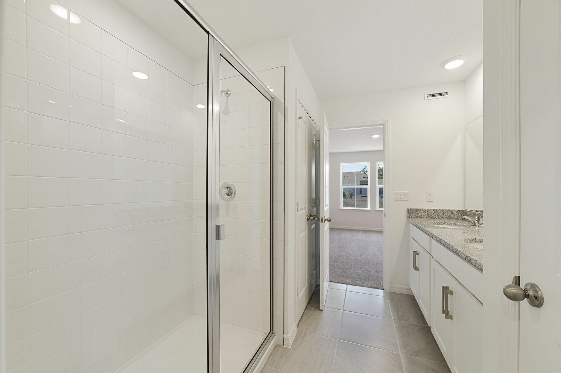Dual sink vanity with a large mirror and shower