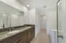 dual sink vanity with water closet, shower and tub