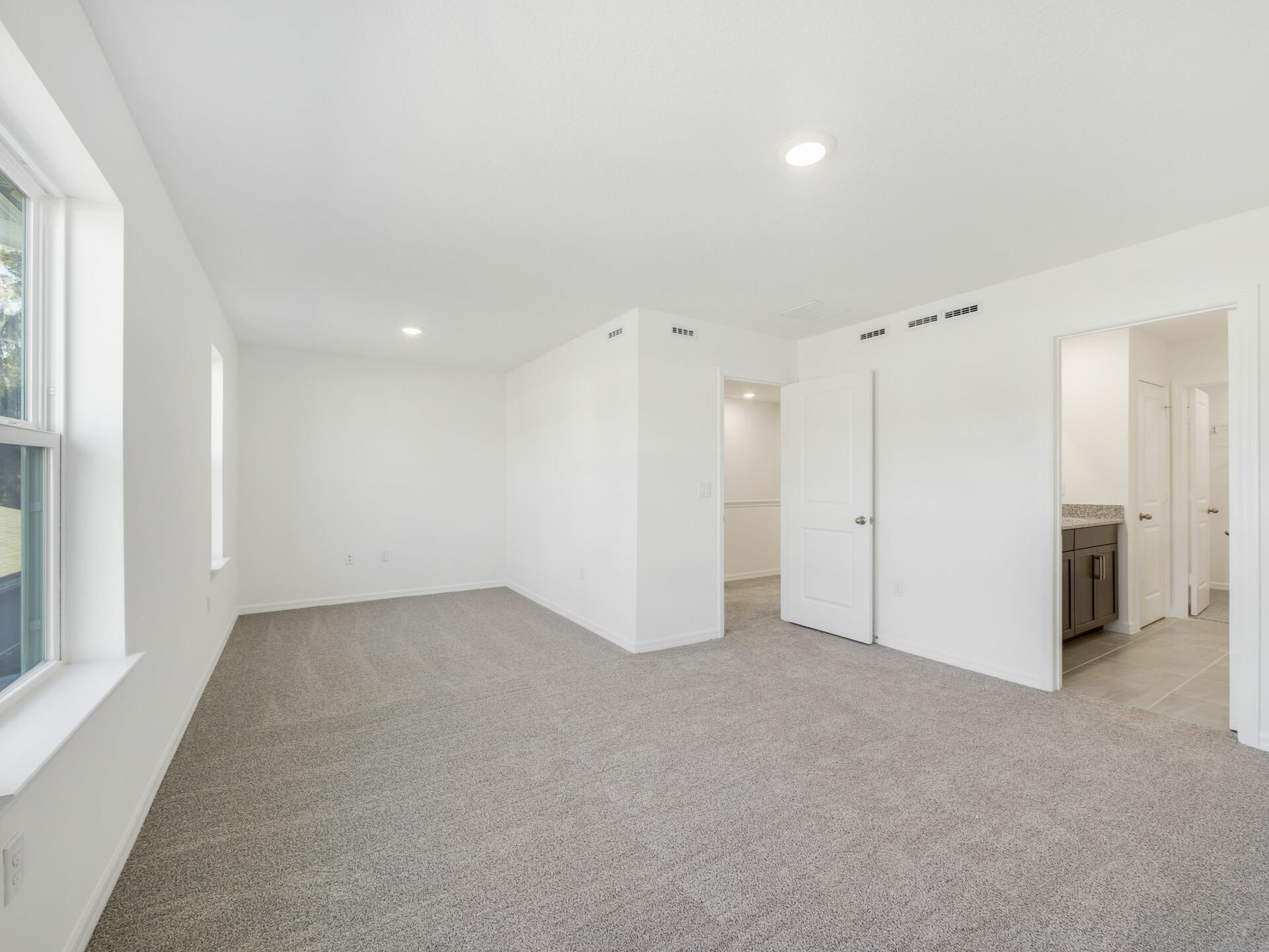 primary bedroom with carpet and sitting area