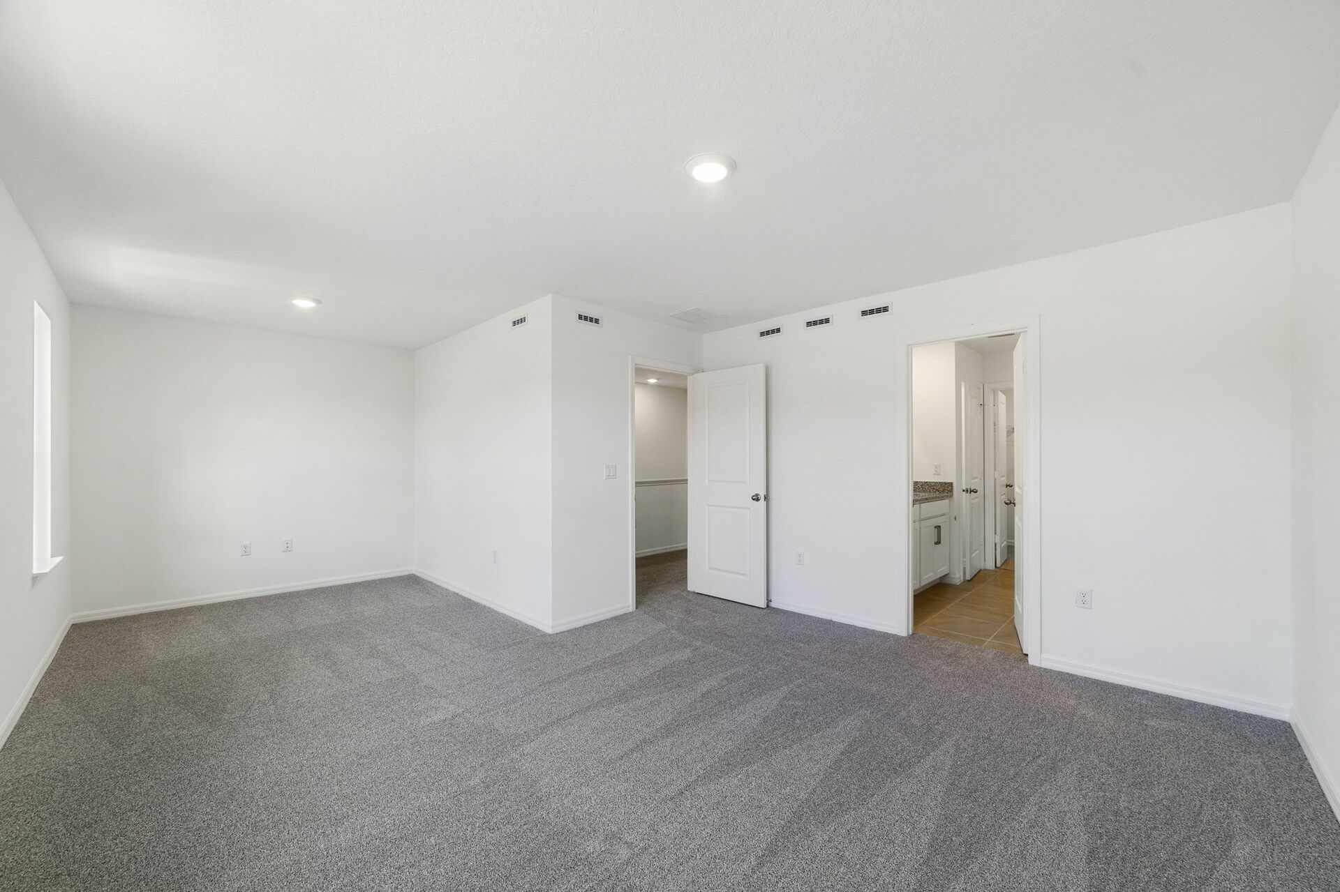 carpet throughout with a sitting room with large windows 