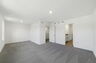 carpet throughout with a sitting room with large windows 