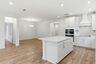 kitchen with wood flooring, white cabinets, and white countertops