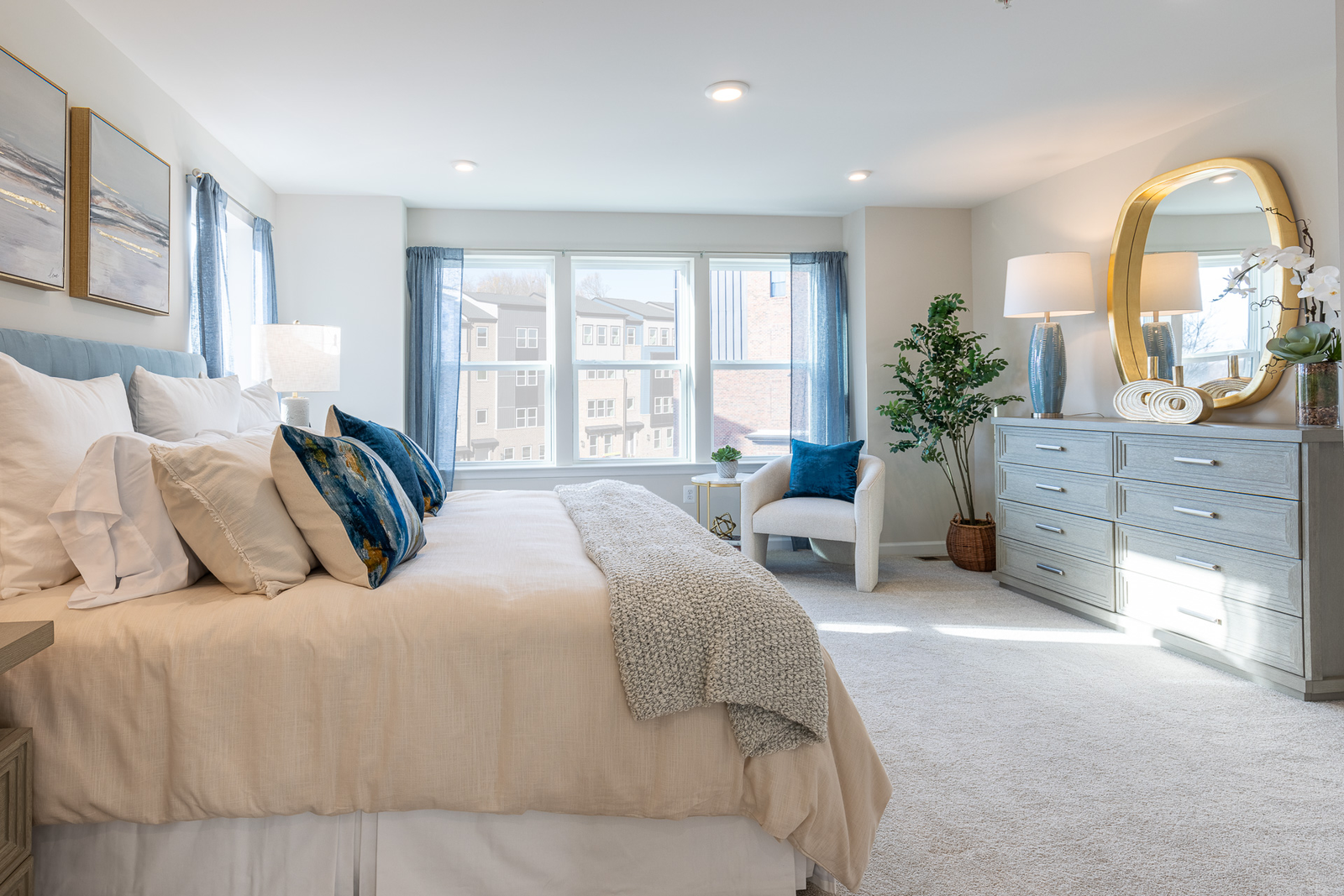 primary suite with a king bed and large windows