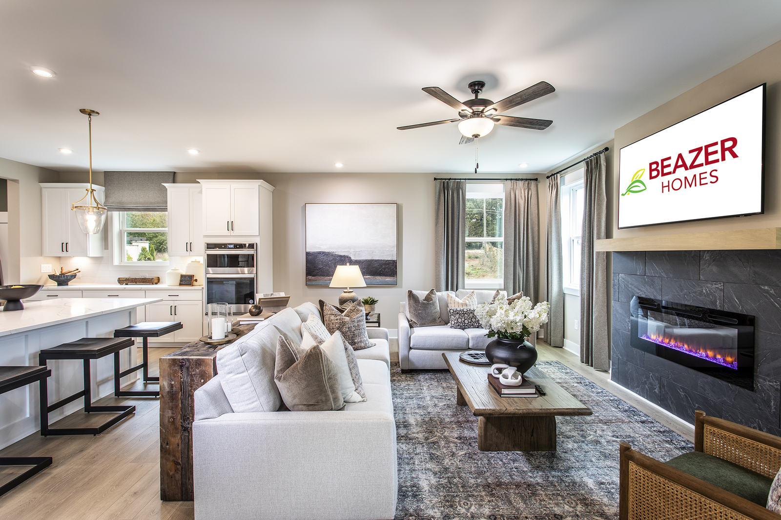 great room with fireplace and light plank flooring